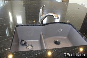 15305 W 93rd Ave, Arvada, CO 80007 - kitchen view of a sink and dark stone counters