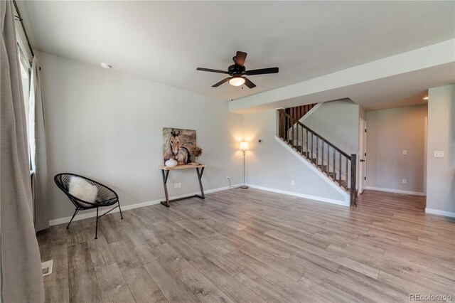 2640 Brookstone Dr Unit B, Milliken, CO 80543 - unfurnished room with stairs, light wood-style flooring, and a ceiling fan