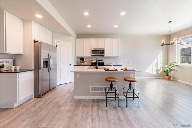 2640 Brookstone Dr Unit B, Milliken, CO 80543 - kitchen with appliances with stainless steel finishes, tasteful backsplash, light wood finished floors, and recessed lighting