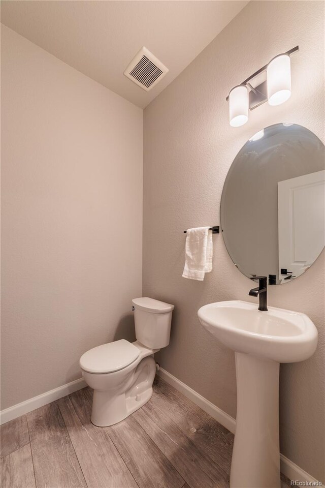 2640 Brookstone Dr Unit B, Milliken, CO 80543 - bathroom with wood finished floors and toilet