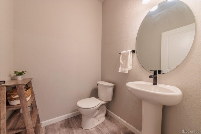 2640 Brookstone Dr Unit B, Milliken, CO 80543 - half bath with wood finished floors and toilet