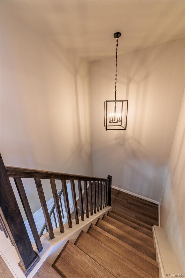 2640 Brookstone Dr Unit B, Milliken, CO 80543 - stairway featuring wood finished floors and a chandelier