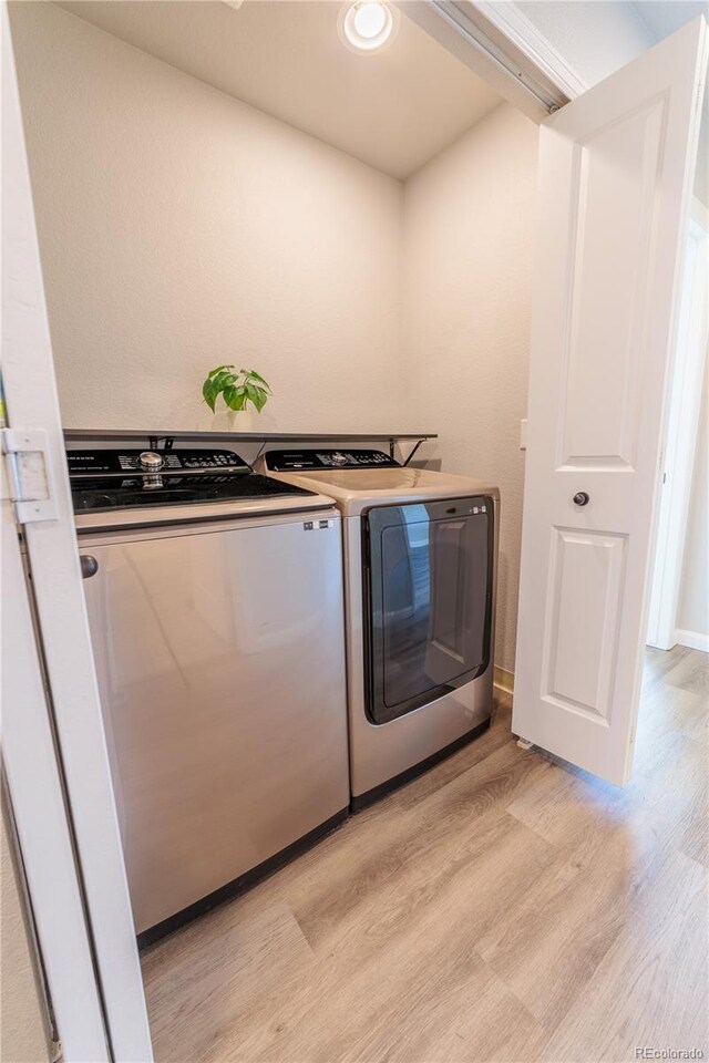2640 Brookstone Dr Unit B, Milliken, CO 80543 - laundry area featuring washing machine and dryer and light wood-type flooring