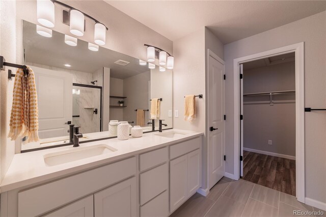 2640 Brookstone Dr Unit B, Milliken, CO 80543 - bathroom with a shower stall, double vanity, and a walk in closet