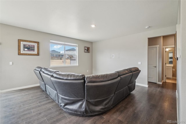 living room featuring recessed lighting, baseboards, and dark wood finished floors