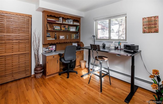 home office with baseboard heating and light wood-type flooring