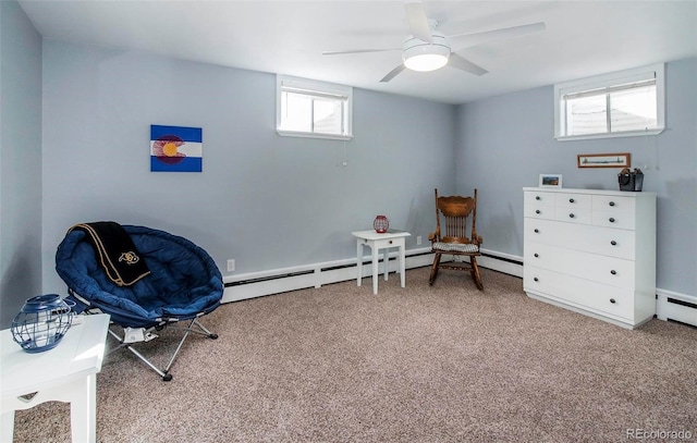 sitting room with a baseboard radiator, ceiling fan, and carpet