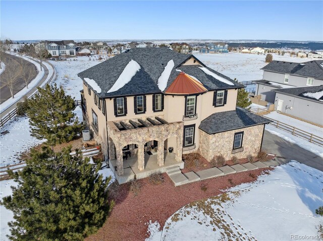 6985 Fallon Cir, Castle Rock, CO 80104 - view of front of property featuring stucco siding, stone siding, a standing seam roof, a residential view, and a metal roof