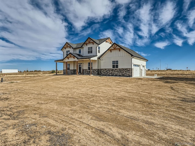 craftsman-style home with covered porch and a garage