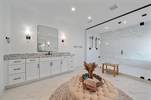 bathroom featuring vanity and a shower with shower door