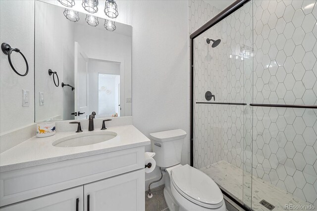 bathroom with a shower with door, toilet, and vanity