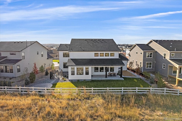 back of house with a patio area and a yard