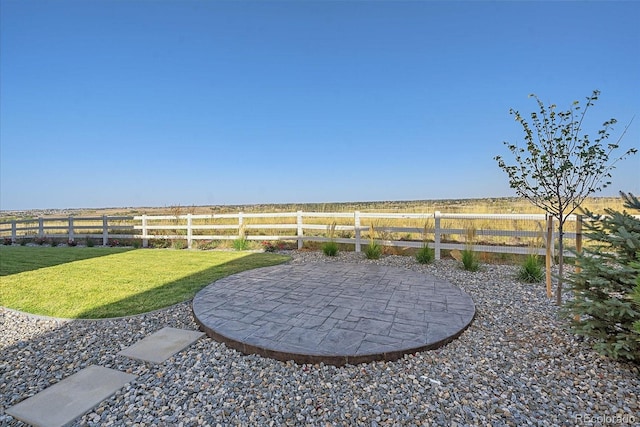 view of yard with a patio area and a rural view