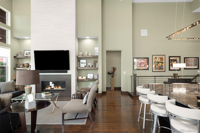 10243 Spring Green Dr, Englewood, CO 80112 - living area featuring a high ceiling, a tile fireplace, and dark wood finished floors