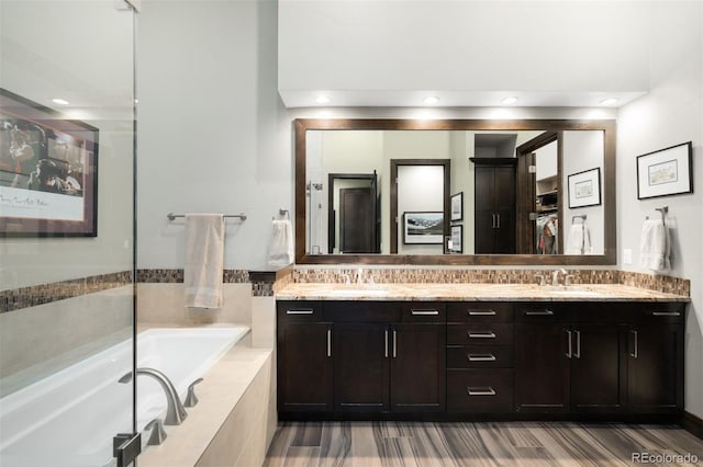 10243 Spring Green Dr, Englewood, CO 80112 - full bath featuring double vanity, a garden tub, wood finished floors, and a closet