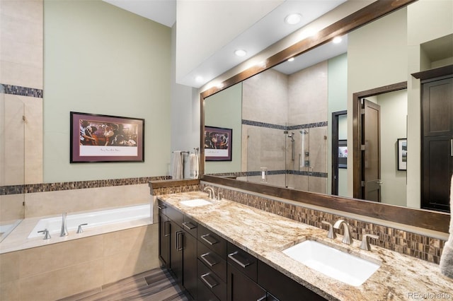 10243 Spring Green Dr, Englewood, CO 80112 - full bathroom featuring a garden tub, a shower stall, double vanity, and recessed lighting