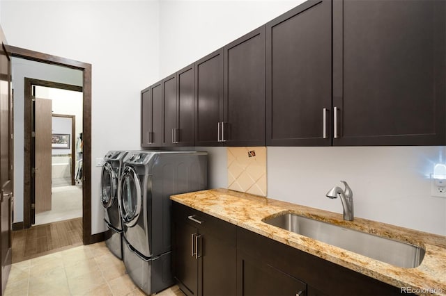 10243 Spring Green Dr, Englewood, CO 80112 - laundry area with cabinet space and washing machine and dryer