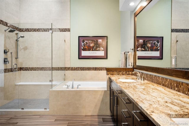 10243 Spring Green Dr, Englewood, CO 80112 - full bath with double vanity, a stall shower, a bath, and wood finished floors