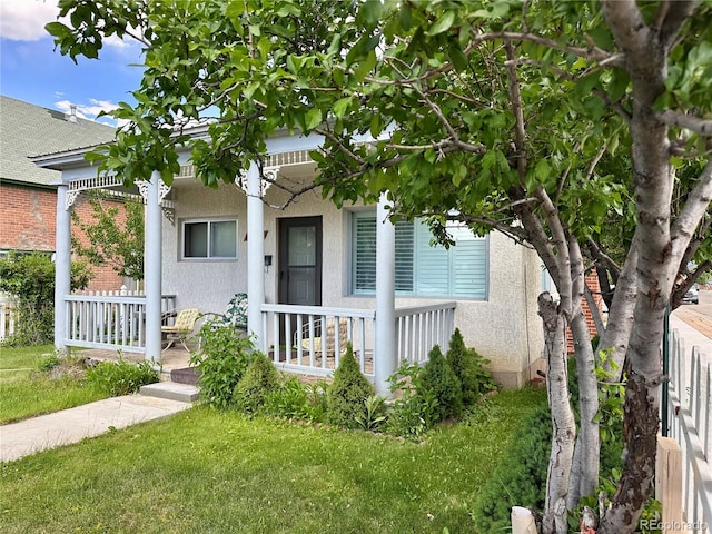 647 D St, Salida, CO 81201 - view of front of property with covered porch, stucco siding, and a front yard