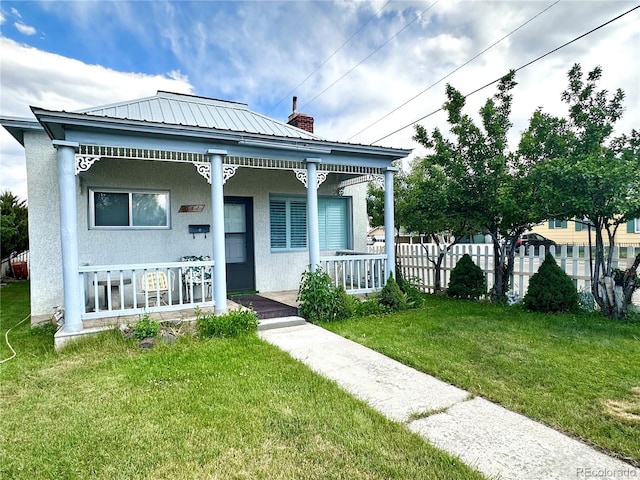 647 D St, Salida, CO 81201 - view of front of home with a porch, stucco siding, a metal roof, and a chimney