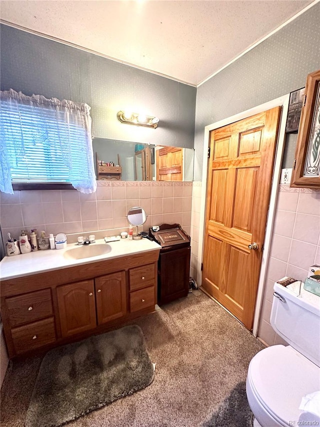 647 D St, Salida, CO 81201 - bathroom featuring tile walls, vanity, and decorative backsplash