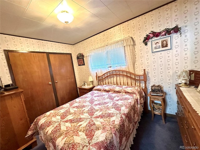 647 D St, Salida, CO 81201 - bedroom featuring wallpapered walls, dark carpet, a closet, and ornamental molding