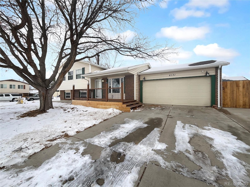 split level home featuring a garage and a porch