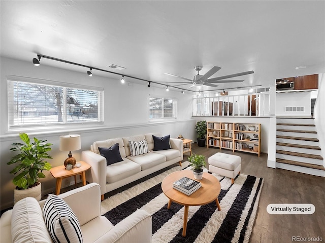 living room featuring wood-type flooring and ceiling fan