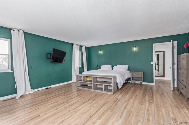 4808 S Ward Way, Morrison, CO 80465 - bedroom with wood finished floors, baseboards, and a textured ceiling