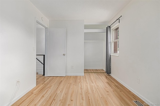 4808 S Ward Way, Morrison, CO 80465 - unfurnished bedroom featuring a closet and wood finished floors