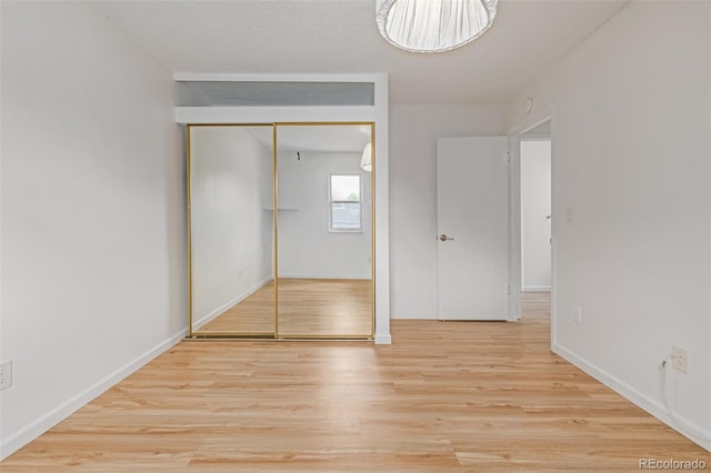 4808 S Ward Way, Morrison, CO 80465 - unfurnished bedroom with wood finished floors and a closet