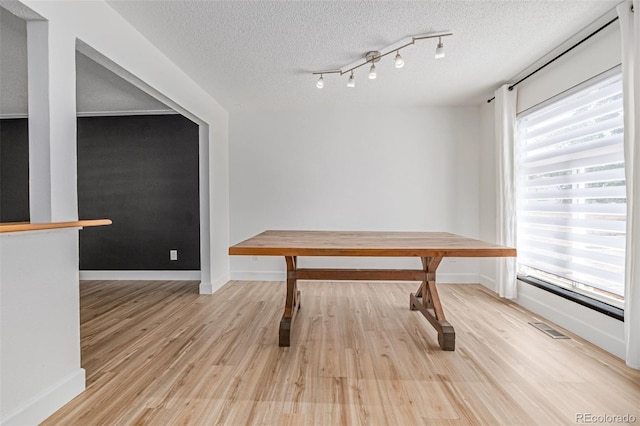 4808 S Ward Way, Morrison, CO 80465 - unfurnished dining area with light wood-style floors and a textured ceiling