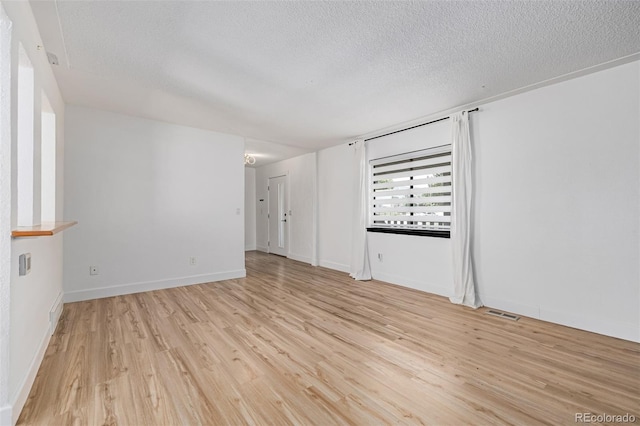 4808 S Ward Way, Morrison, CO 80465 - spare room with a textured ceiling and light wood-style floors