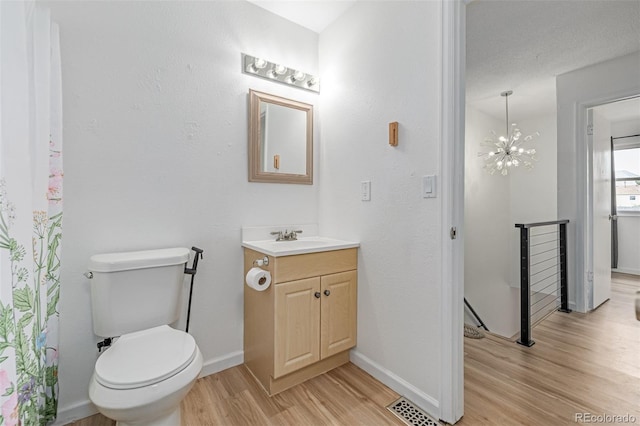 4808 S Ward Way, Morrison, CO 80465 - bathroom featuring wood finished floors, vanity, and a chandelier