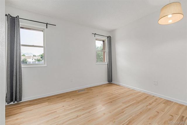 4808 S Ward Way, Morrison, CO 80465 - unfurnished room with healthy amount of natural light and wood finished floors