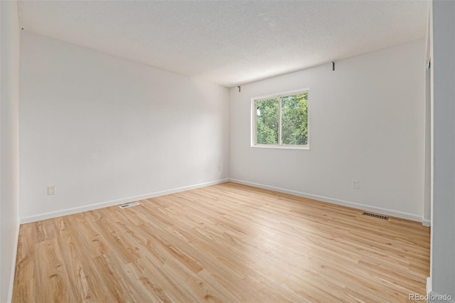 4808 S Ward Way, Morrison, CO 80465 - empty room featuring light wood-style flooring and a textured ceiling