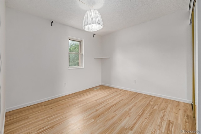 4808 S Ward Way, Morrison, CO 80465 - unfurnished room with a textured ceiling and wood finished floors