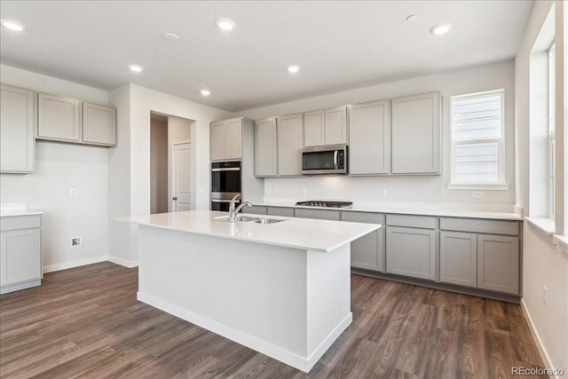 1281 Loraine Cir N, Lafayette, CO 80026 - kitchen featuring appliances with stainless steel finishes, a sink, gray cabinetry, dark wood-style flooring, and recessed lighting