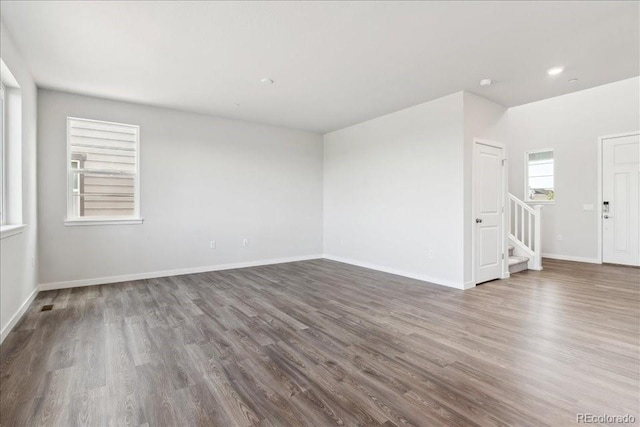 1281 Loraine Cir N, Lafayette, CO 80026 - unfurnished room with stairs, wood finished floors, baseboards, and recessed lighting