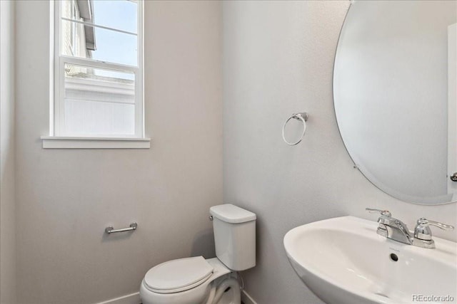 1281 Loraine Cir N, Lafayette, CO 80026 - half bath featuring a sink, toilet, and baseboards