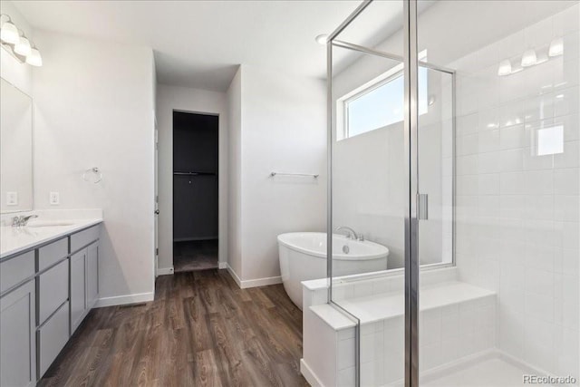 1281 Loraine Cir N, Lafayette, CO 80026 - bathroom with a stall shower, vanity, a freestanding bath, and wood finished floors