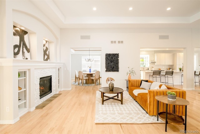 living room with built in features and light hardwood / wood-style floors