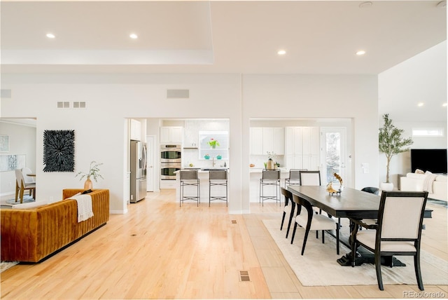 dining room featuring sink and light hardwood / wood-style floors