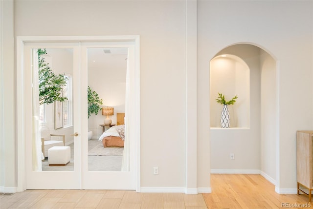 hallway with light hardwood / wood-style flooring