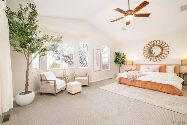 bedroom with vaulted ceiling, ceiling fan, light colored carpet, and multiple windows