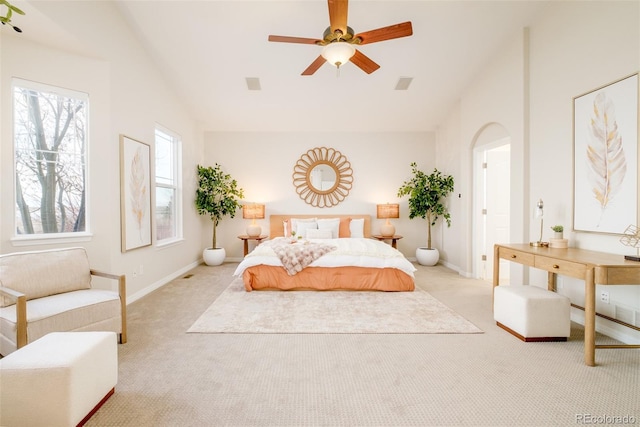 carpeted bedroom with ceiling fan and vaulted ceiling