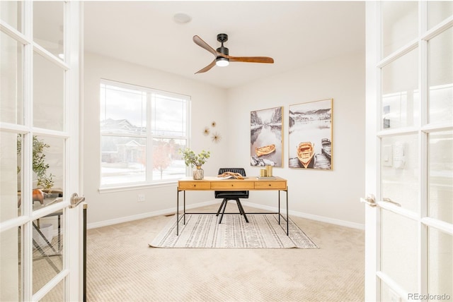 carpeted home office with ceiling fan and french doors