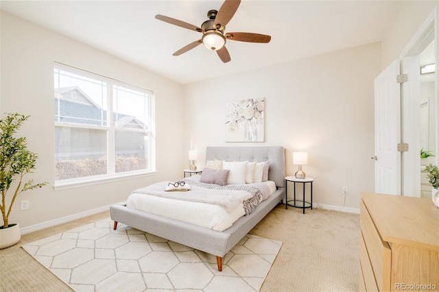 bedroom with ceiling fan and light carpet