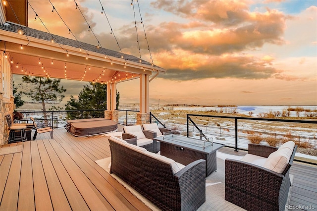 snow covered deck featuring an outdoor living space