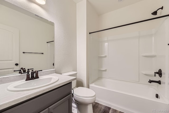 full bathroom with vanity, wood-type flooring, toilet, and shower / bath combination